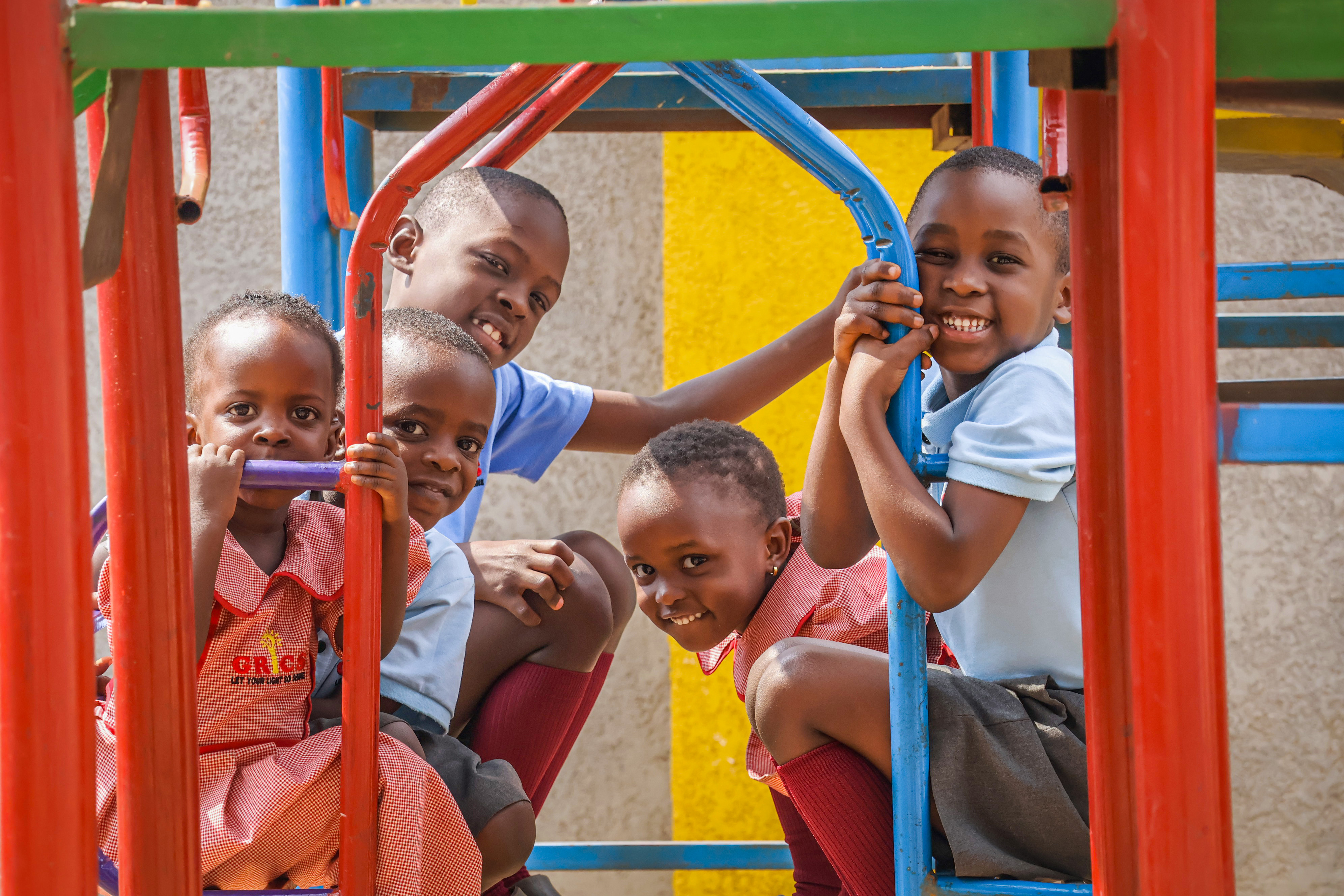 Group of GRICS learners posing together on the climbing frame